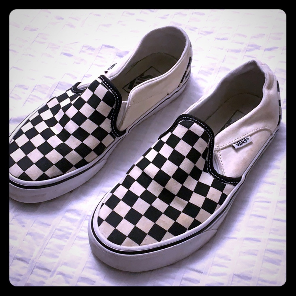 Black and white checkered Vans slip ons